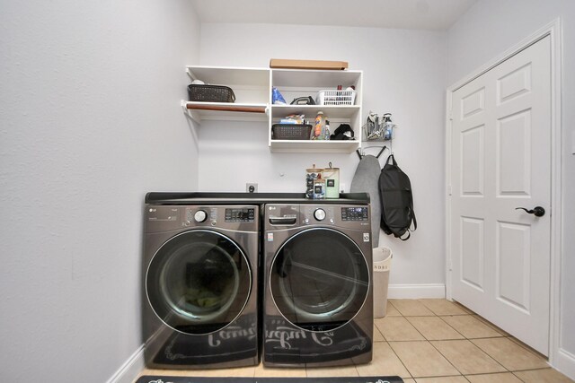 11311 Burmese Ln, Sugar Land, TX 77478 - washroom featuring independent washer and dryer, light tile patterned floors, and baseboards