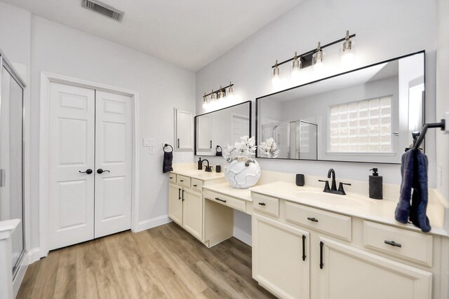 11311 Burmese Ln, Sugar Land, TX 77478 - bathroom with a shower stall, double vanity, and wood finished floors