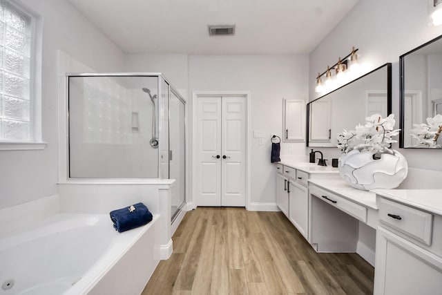 11311 Burmese Ln, Sugar Land, TX 77478 - full bath featuring a shower stall, a bath, vanity, and wood finished floors