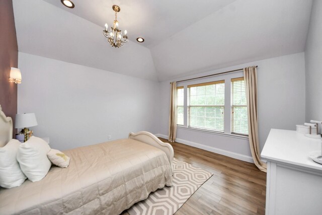11311 Burmese Ln, Sugar Land, TX 77478 - bedroom featuring vaulted ceiling, a chandelier, wood finished floors, and baseboards