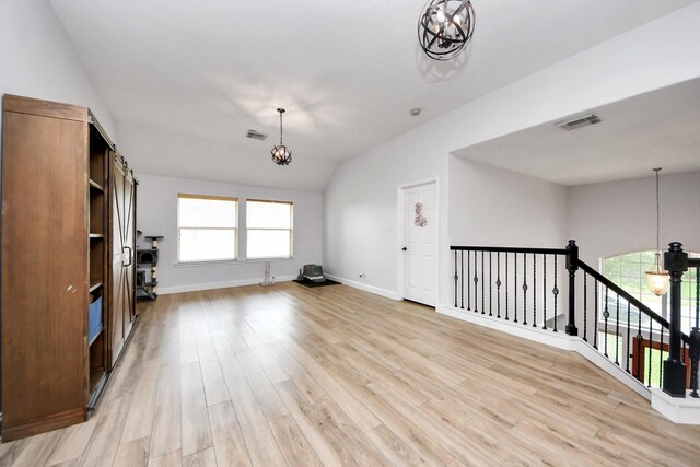 11311 Burmese Ln, Sugar Land, TX 77478 - unfurnished living room with a chandelier, light wood-type flooring, baseboards, and lofted ceiling