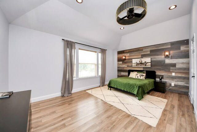 11311 Burmese Ln, Sugar Land, TX 77478 - bedroom featuring vaulted ceiling, wooden walls, wood finished floors, recessed lighting, and an accent wall