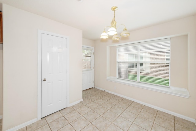 3226 Woodwind Rd, Montgomery, TX 77356 - unfurnished dining area featuring a chandelier and light tile patterned flooring