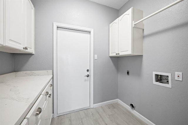 14134 Palo Seco Dr, Corpus Christi, TX 78418 - laundry area featuring cabinet space, washer hookup, hookup for an electric dryer, baseboards, and light wood-type flooring