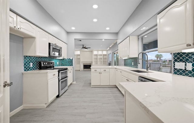 14134 Palo Seco Dr, Corpus Christi, TX 78418 - kitchen featuring appliances with stainless steel finishes, a sink, ceiling fan, recessed lighting, and a peninsula