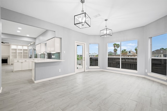 14134 Palo Seco Dr, Corpus Christi, TX 78418 - unfurnished living room with a chandelier, plenty of natural light, light wood-style flooring, baseboards, and recessed lighting