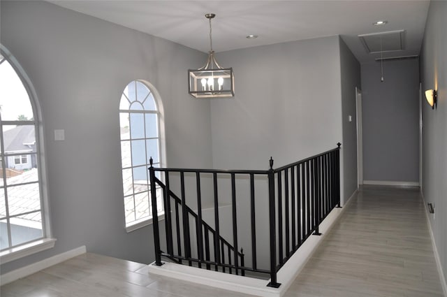 14134 Palo Seco Dr, Corpus Christi, TX 78418 - stairway featuring attic access, plenty of natural light, wood finished floors, and baseboards