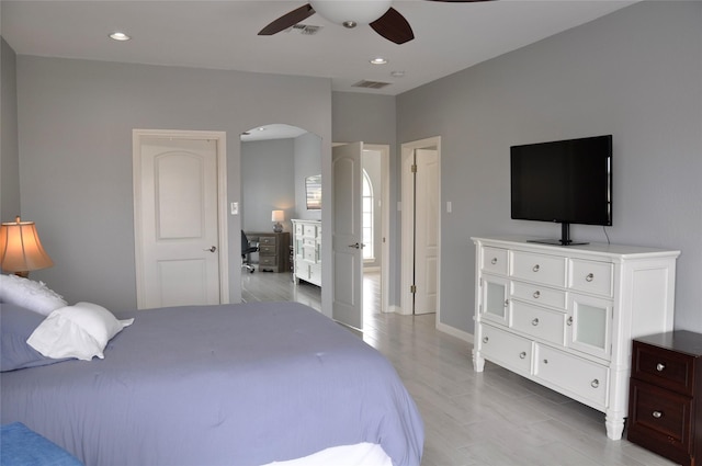 14134 Palo Seco Dr, Corpus Christi, TX 78418 - bedroom featuring arched walkways, recessed lighting, ceiling fan, baseboards, and light wood-style flooring