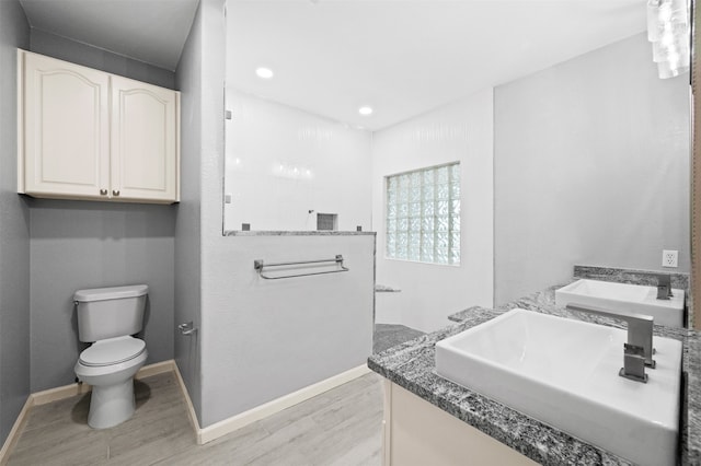 14134 Palo Seco Dr, Corpus Christi, TX 78418 - bathroom featuring wood finished floors, toilet, a walk in shower, vanity, and recessed lighting