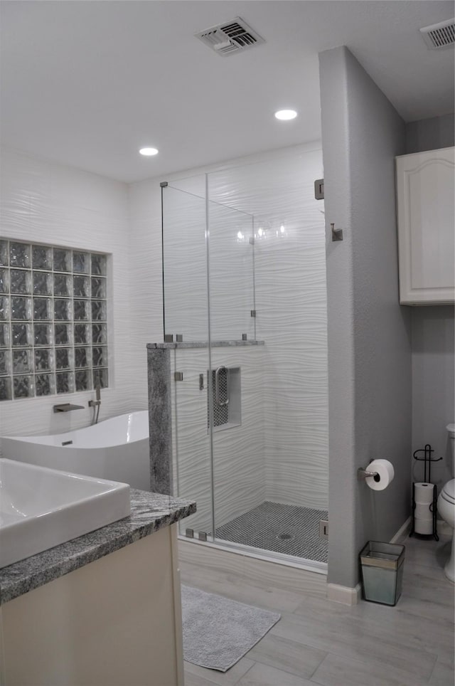 14134 Palo Seco Dr, Corpus Christi, TX 78418 - bathroom with a shower stall, vanity, toilet, and recessed lighting