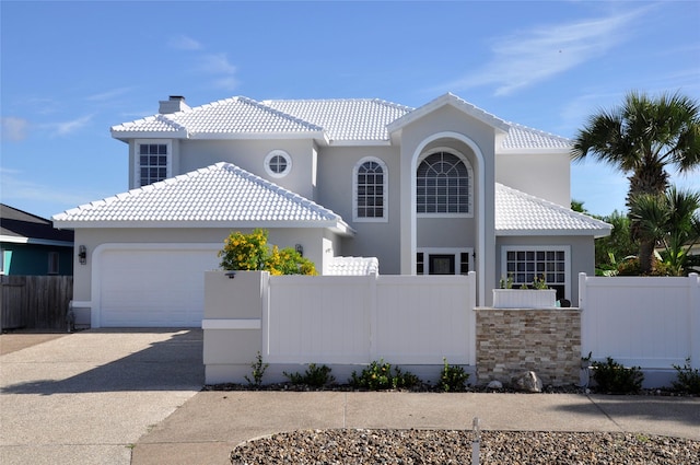 14134 Palo Seco Dr, Corpus Christi, TX 78418 - mediterranean / spanish-style home with driveway, a garage, a fenced front yard, and a chimney
