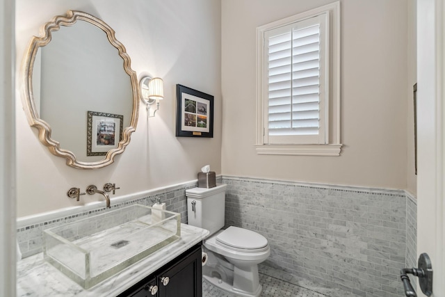 6014 Floyd St, Houston, TX 77007 - bathroom featuring tile walls, wainscoting, vanity, and tile patterned flooring