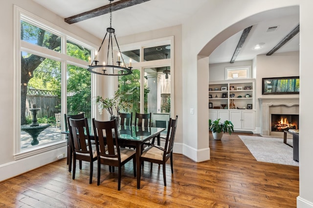 6014 Floyd St, Houston, TX 77007 - dining room featuring beamed ceiling, hardwood / wood-style flooring, healthy amount of natural light, and arched walkways