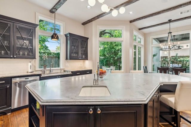 6014 Floyd St, Houston, TX 77007 - kitchen with stainless steel dishwasher, healthy amount of natural light, a center island with sink, light wood finished floors, and recessed lighting