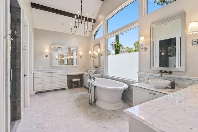 6014 Floyd St, Houston, TX 77007 - bathroom featuring a freestanding bath, marble finish floors, two vanities, a towering ceiling, and wainscoting