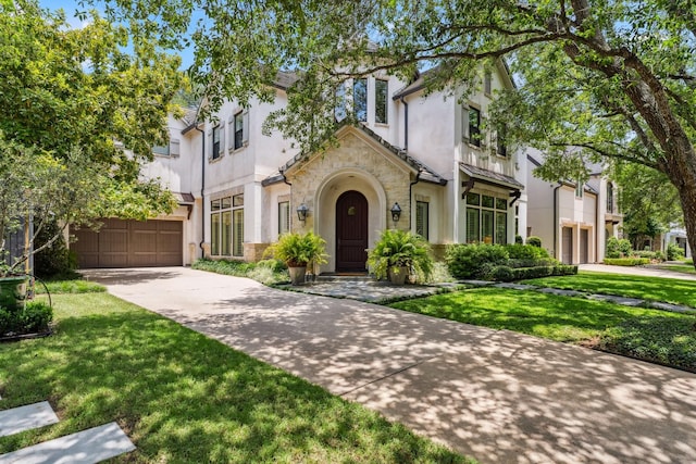 6014 Floyd St, Houston, TX 77007 - view of front of property featuring driveway, stucco siding, stone siding, and a front yard