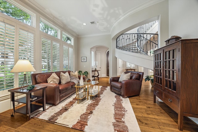 6014 Floyd St, Houston, TX 77007 - living area with arched walkways, wood-type flooring, ornamental molding, stairway, and recessed lighting