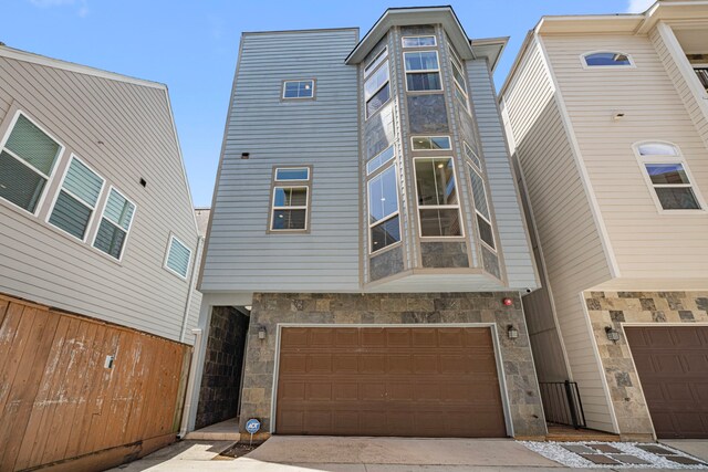 2022 Sabine St, Houston, TX 77007 - view of front of house featuring stone siding and an attached garage