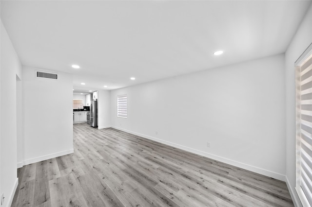 1106 W Tri Oaks Ln Unit 134, Houston, TX 77043 - unfurnished living room featuring recessed lighting and light wood-type flooring