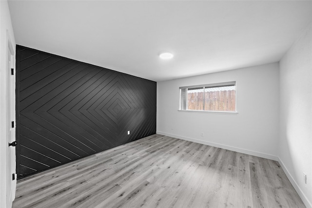 1106 W Tri Oaks Ln Unit 134, Houston, TX 77043 - empty room with light wood-style flooring and baseboards