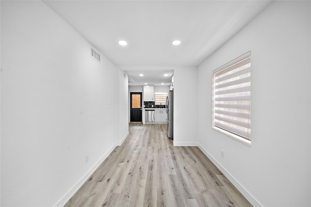 1106 W Tri Oaks Ln Unit 134, Houston, TX 77043 - hall featuring light wood-style floors and recessed lighting