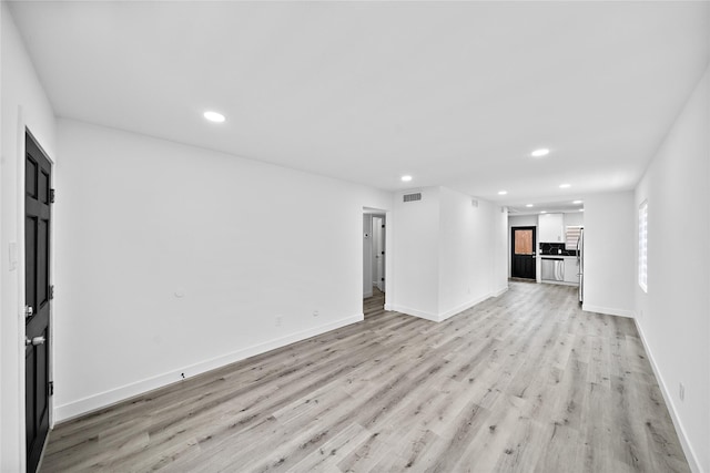 1106 W Tri Oaks Ln Unit 134, Houston, TX 77043 - unfurnished living room with recessed lighting and light wood finished floors