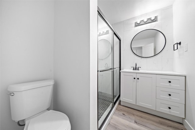 1106 W Tri Oaks Ln Unit 134, Houston, TX 77043 - full bathroom featuring vanity, a stall shower, and wood finished floors