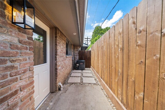 1106 W Tri Oaks Ln Unit 134, Houston, TX 77043 - view of home's exterior with a central air condition unit and brick siding
