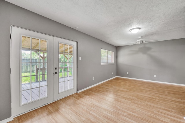 20110 Misty Pines Dr, Humble, TX 77346 - doorway to outside with french doors, a textured ceiling, light wood-style flooring, ceiling fan, and baseboards