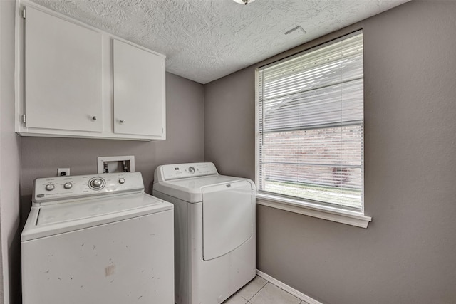 20110 Misty Pines Dr, Humble, TX 77346 - washroom featuring separate washer and dryer, cabinet space, healthy amount of natural light, baseboards, and a textured ceiling