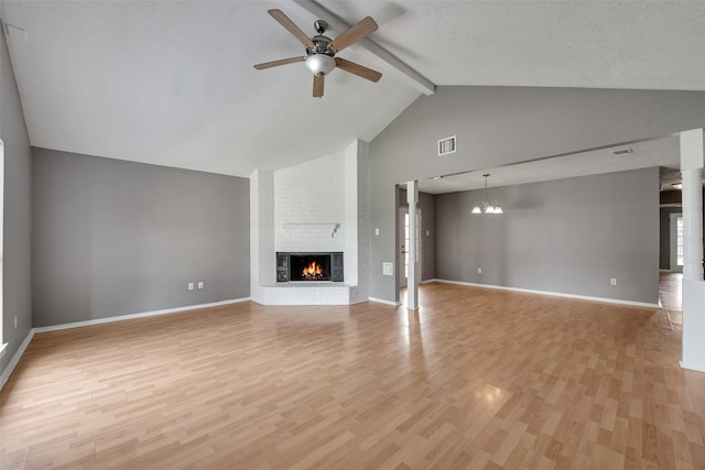 20110 Misty Pines Dr, Humble, TX 77346 - unfurnished living room with ceiling fan, a brick fireplace, light wood-style flooring, beamed ceiling, and high vaulted ceiling