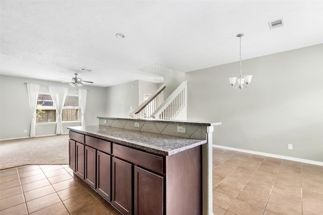 6015 Coleus St, Crosby, TX 77532 - kitchen featuring ceiling fan, baseboards, light tile patterned floors, and dark brown cabinetry
