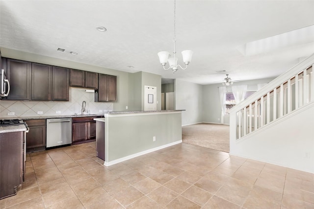 6015 Coleus St, Crosby, TX 77532 - kitchen with appliances with stainless steel finishes, a chandelier, a ceiling fan, tasteful backsplash, and dark brown cabinets