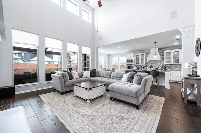 23230 Banfield Creek Ct, Katy, TX 77493 - living area with ceiling fan, a high ceiling, decorative columns, dark wood-style flooring, and recessed lighting