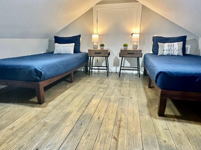 1088 Johnson Rd, Gilchrist, TX 77617 - bedroom featuring wood-type flooring and vaulted ceiling