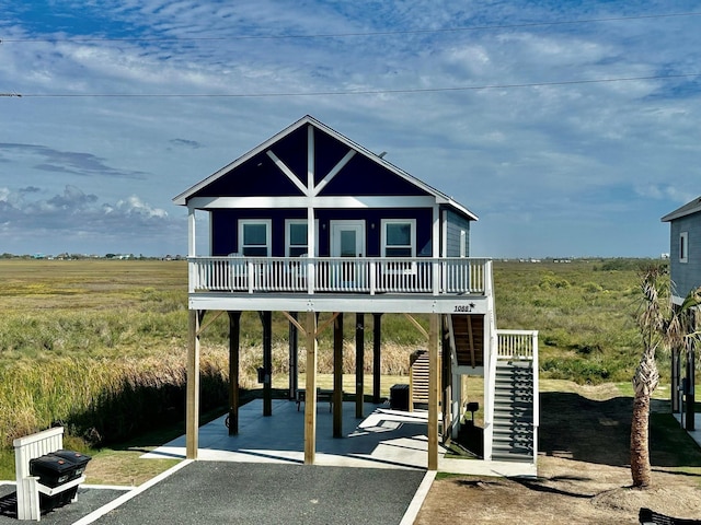 1088 Johnson Rd, Gilchrist, TX 77617 - view of front of home featuring a carport, stairway, and a deck
