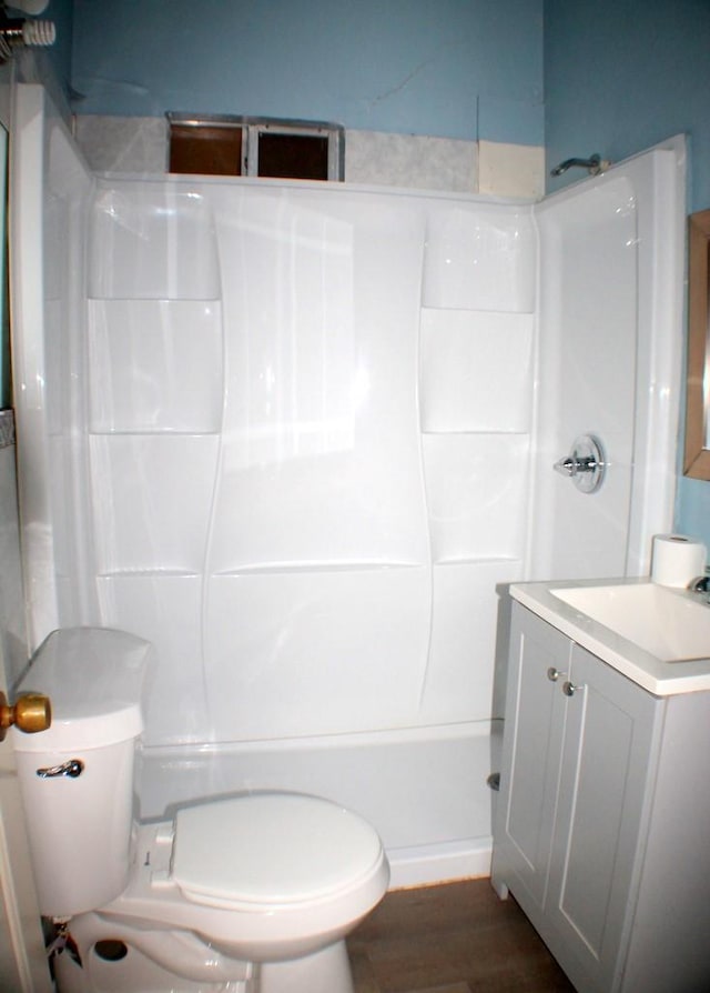 1611 Chapman St, Houston, TX 77009 - full bath featuring vanity, toilet, wood finished floors, and tub / shower combination