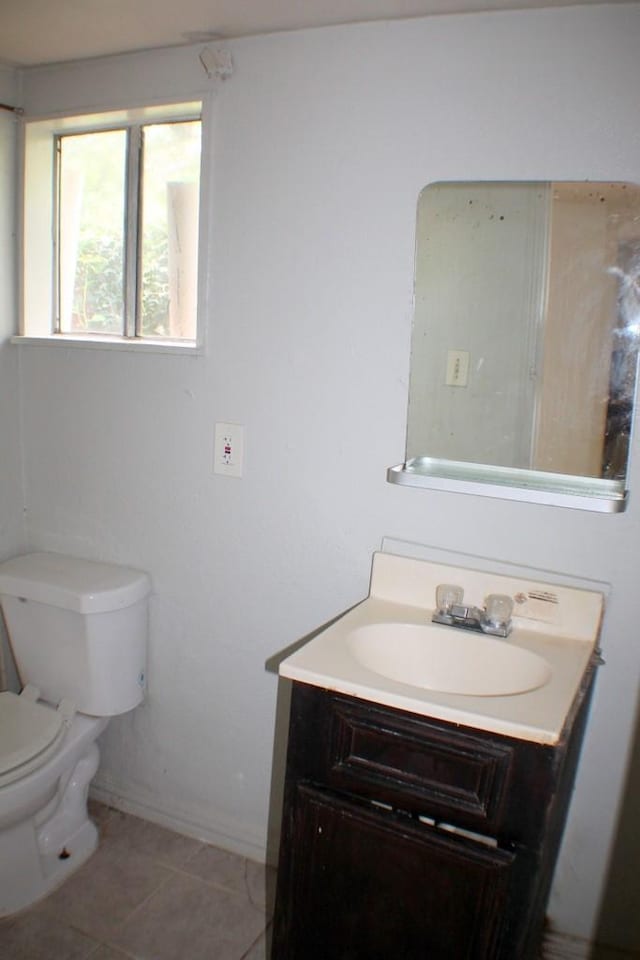 1611 Chapman St, Houston, TX 77009 - half bathroom featuring vanity, toilet, tile patterned flooring, and baseboards