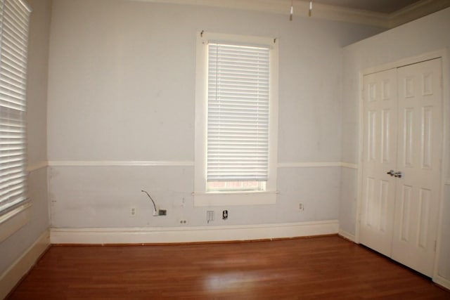 1611 Chapman St, Houston, TX 77009 - unfurnished bedroom featuring wood finished floors, crown molding, a closet, and baseboards