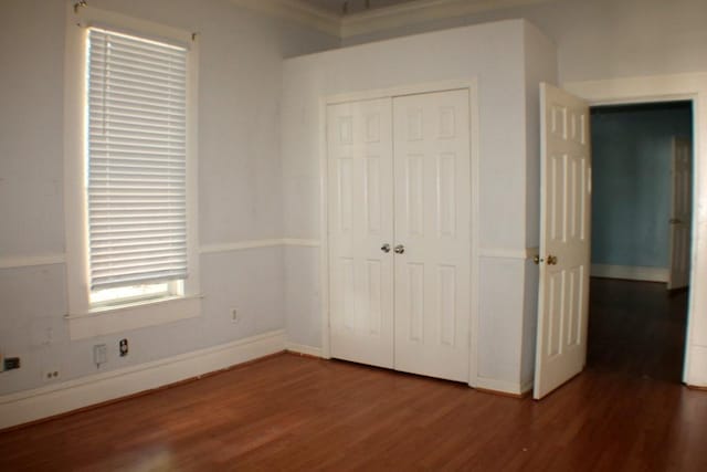 1611 Chapman St, Houston, TX 77009 - unfurnished bedroom with wood finished floors, a closet, and baseboards