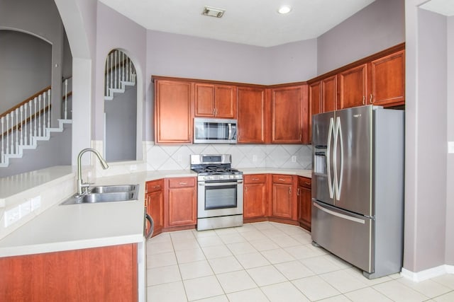 2705 Salt Grass Cir, Deer Park, TX 77536 - kitchen featuring appliances with stainless steel finishes, a sink, light countertops, tasteful backsplash, and light tile patterned floors