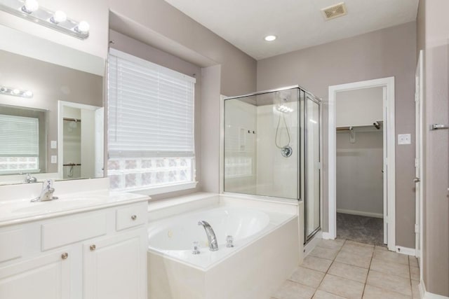 2705 Salt Grass Cir, Deer Park, TX 77536 - bathroom with a walk in closet, a stall shower, a bath, and vanity