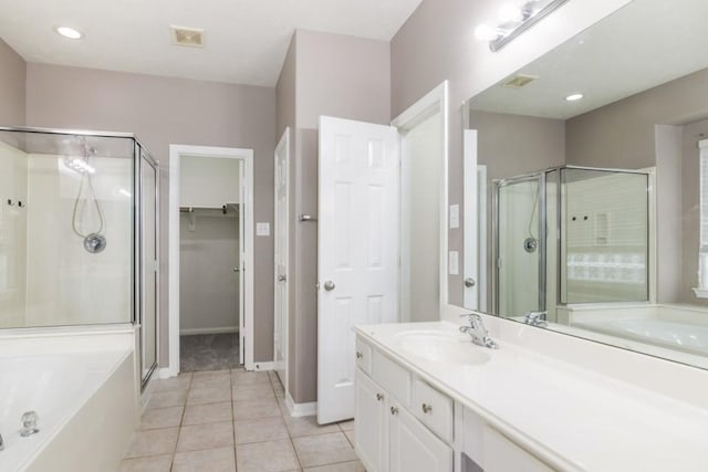 2705 Salt Grass Cir, Deer Park, TX 77536 - bathroom with a shower stall, vanity, a garden tub, tile patterned floors, and baseboards