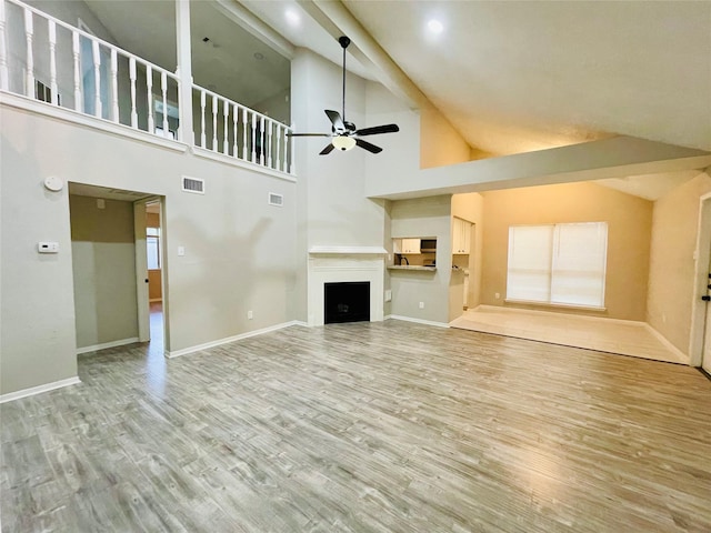 16303 Napa Vine Dr, Houston, TX 77053 - unfurnished living room featuring a ceiling fan, wood finished floors, high vaulted ceiling, baseboards, and a fireplace
