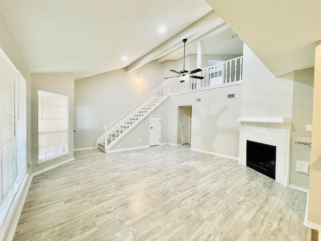 16303 Napa Vine Dr, Houston, TX 77053 - unfurnished living room with stairs, a ceiling fan, wood finished floors, a fireplace, and baseboards