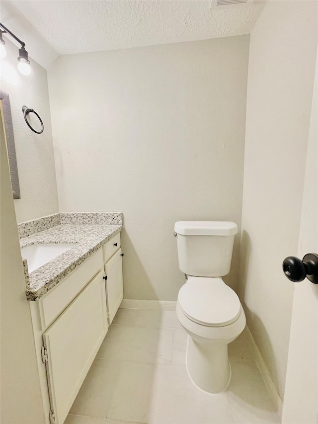 16303 Napa Vine Dr, Houston, TX 77053 - bathroom featuring vanity, toilet, a textured ceiling, and baseboards