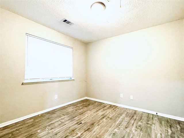 16303 Napa Vine Dr, Houston, TX 77053 - unfurnished room with wood finished floors, baseboards, and a textured ceiling