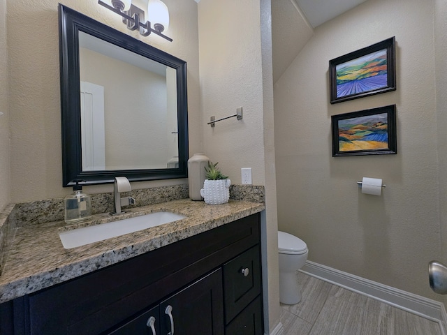 12645 Rip Van Winkle Dr Unit 26, Houston, TX 77024 - bathroom with toilet, vanity, and baseboards