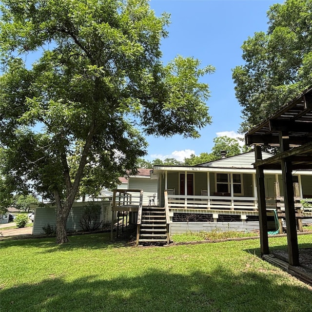 11 Sherry Ln, Coldspring, TX 77331 - back of property with a lawn and a wooden deck