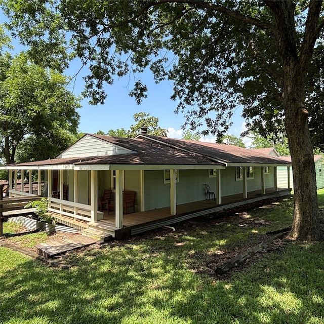 11 Sherry Ln, Coldspring, TX 77331 - rear view of house with a lawn and a porch
